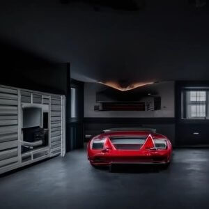 Red car parked inside empty room