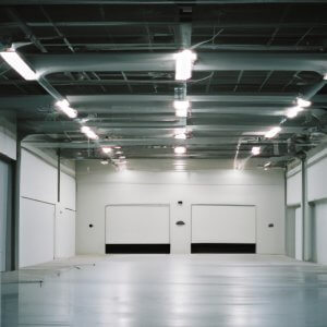 White two door garage empty with lights